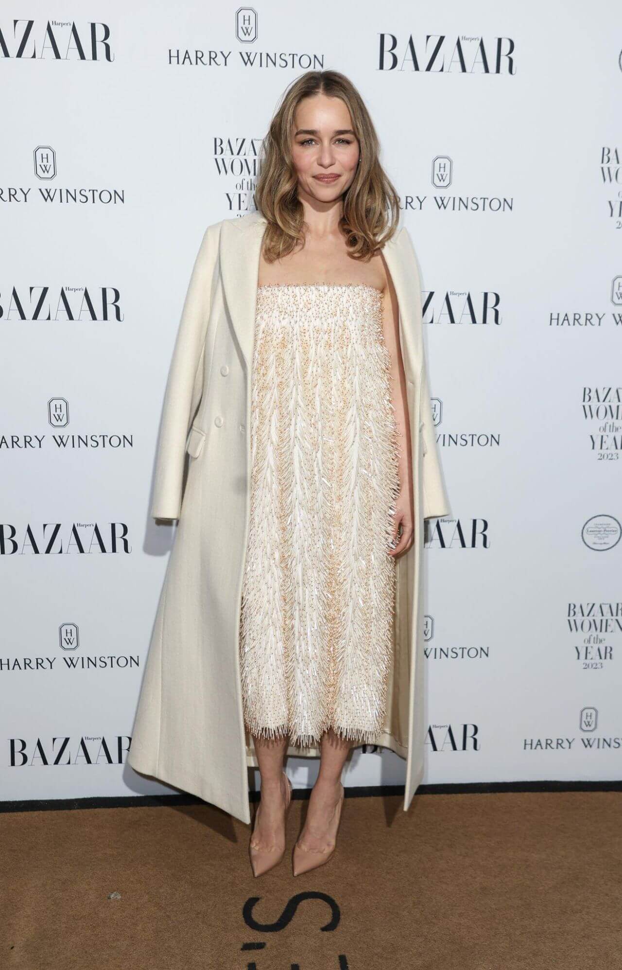 Emilia Clarke in White Overcoat With Long Dress