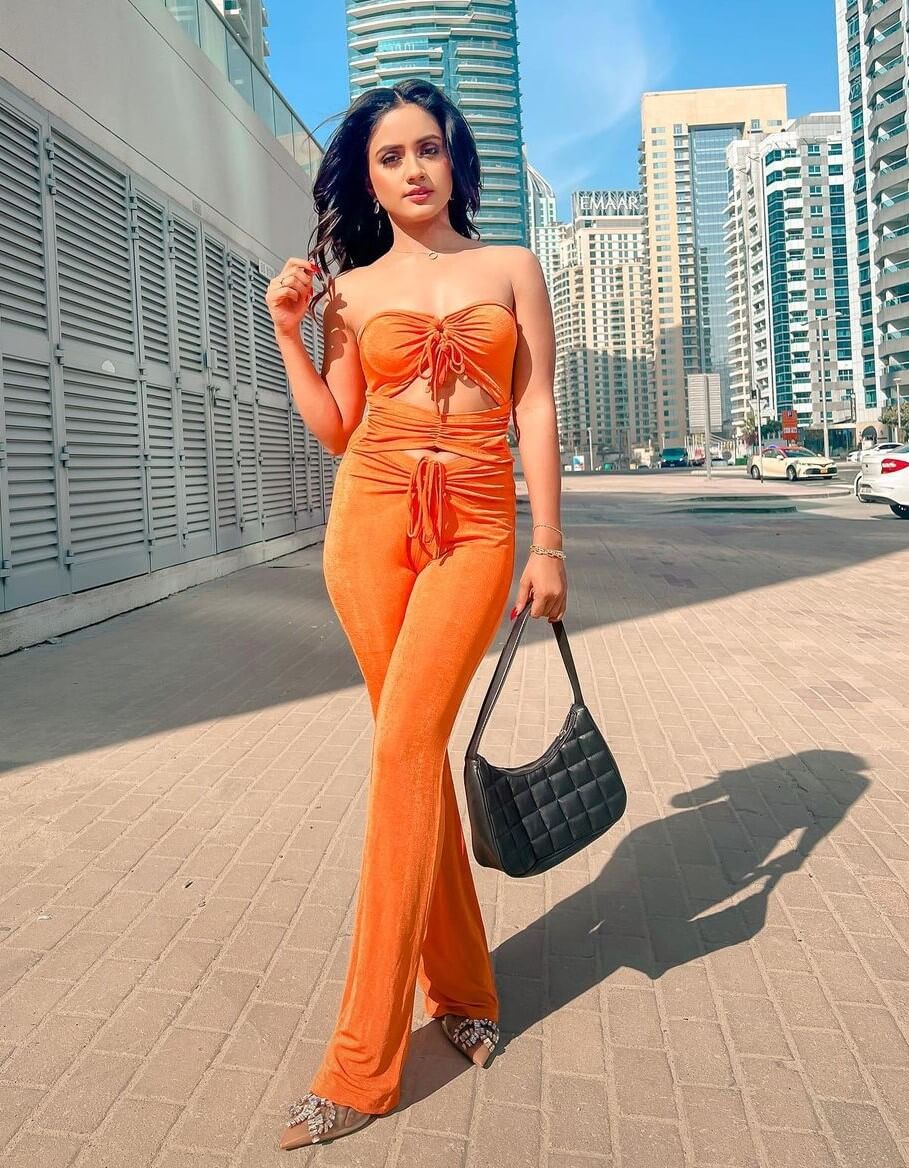 Nisha Guragain In Orange Strapless Cut Out Jumpsuit