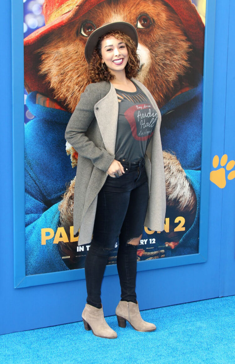 Gloria Govan In Olive Green T-shirt And Ripped Jeans with a Jacket