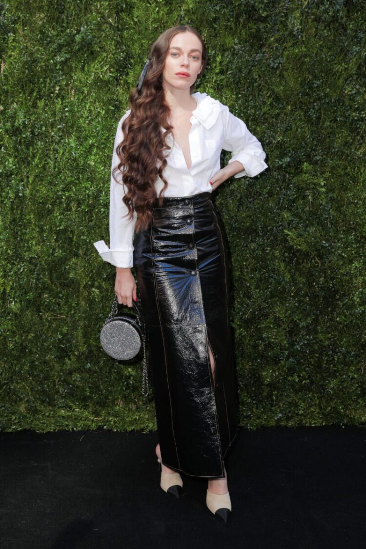 Hailey Gates  In a White Shirt With a Leather Long Skirt