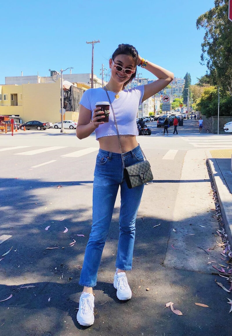 Emily-Mariko-In-White-Crop Top-With-Blue-Jeans