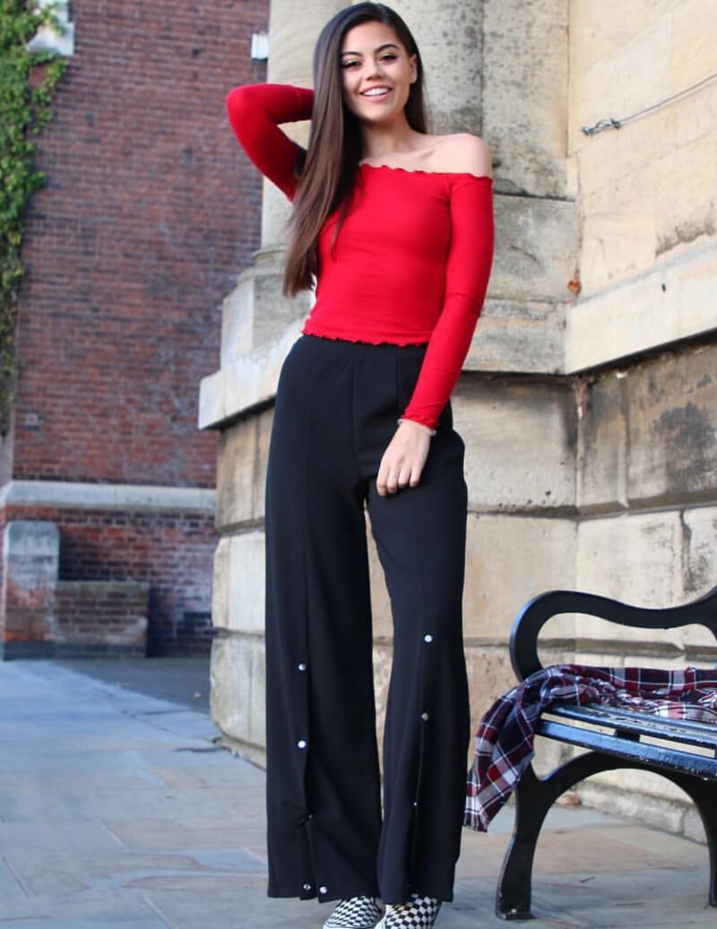 Emily Canham In a red off-shoulder Top With Pants