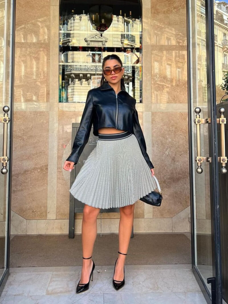 Ava Salmac In Black Leather Jacket With Pleated Skirt