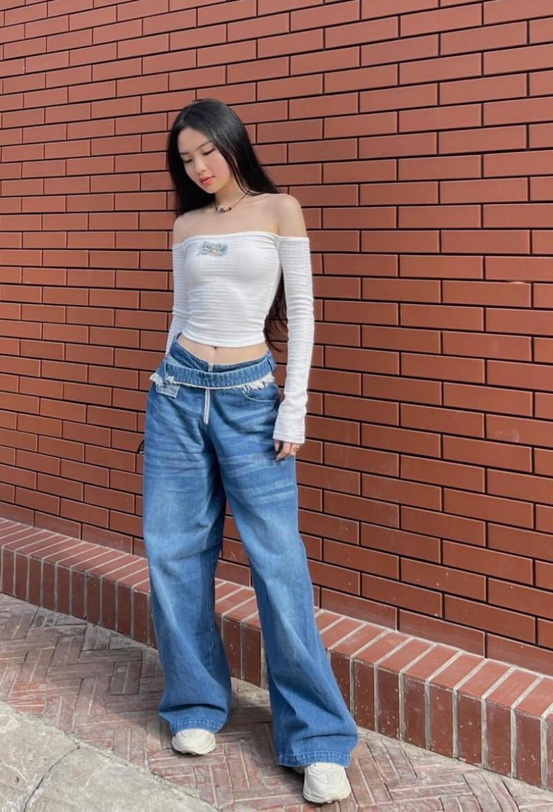 Thao Vy In White Off Shoulder Top With Denim Bottoms